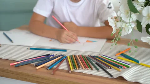 Authentic smiling boy drawing at the table in the living room Stock Footage 115089956