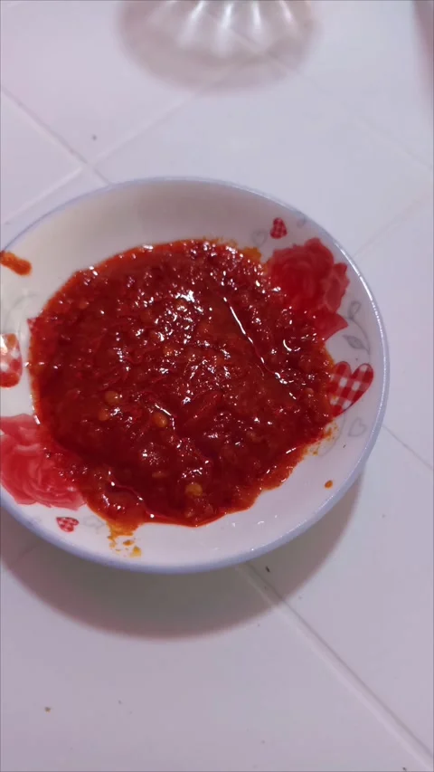 Authentic spicy red harissa paste in a patterned ceramic bowl Stock-Footage 334236209