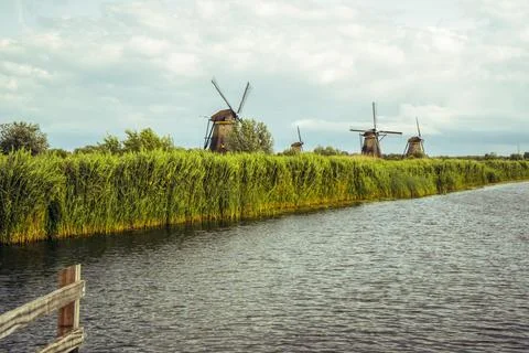 Authentic stone windmills of Kinderdijk over the water Stock Photos
