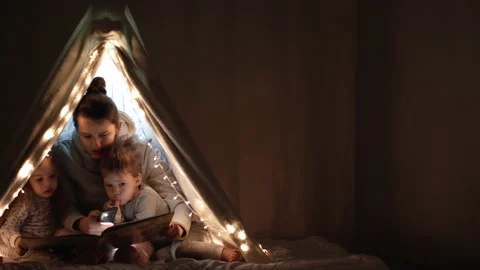 Authentic tender cute mom and preschool kids boy and girl in tent at home. young Stock Footage 146470758