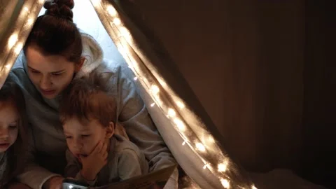 Authentic tender cute mom and preschool kids boy and girl in tent at home. young Stock Footage 146551950