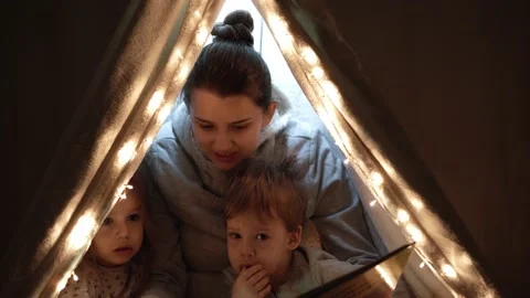 Authentic tender cute mom and preschool kids boy and girl in tent at home. young Stock Footage 146618724