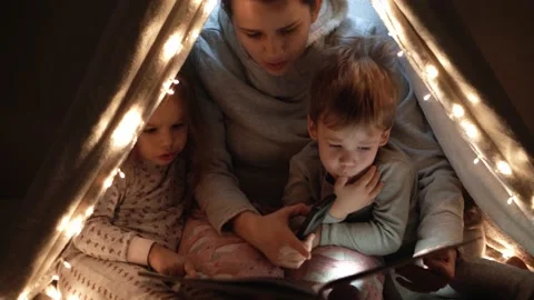 Authentic tender cute mom and preschool kids boy and girl in tent at home. young Stock Footage 146669175