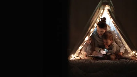 Authentic tender cute mom and preschool kids boy and girl in tent at home. young Stock Footage 146926661