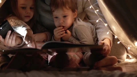 Authentic tender cute mom and preschool kids boy and girl in tent at home. young Stock Footage 147224192