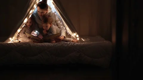 Authentic tender cute mom and preschool kids boy and girl in tent at home. young Stock Footage 147357009
