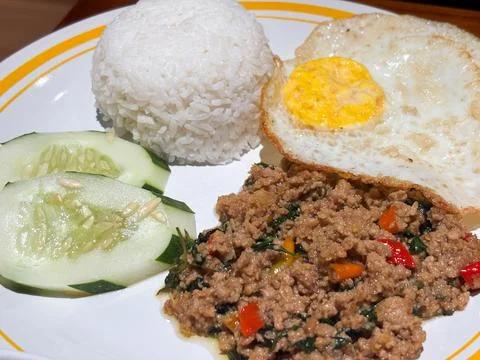 Authentic Thai Basil Pork (Pad Krapow Moo) over Steamed Rice with Fried Egg Stock Photos