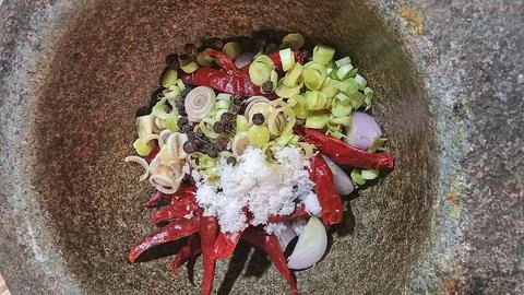 Authentic Thai Curry Paste Ingredients in a Traditional Stone Mortar Stock Photos