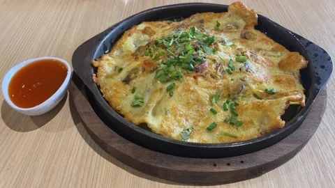 Authentic Thai Fried Crispy Clam Mussel Omelet Pancake In Hot Iron Pan Skillet Stock Footage 233229328