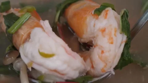 Authentic Thai Tom Yum Goong Spicy Shrimp Soup with Herbs and Chili Stock Footage 338212108