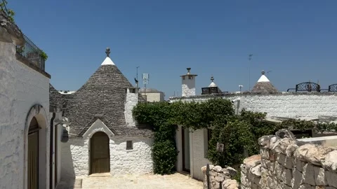 Authentic trullo house with whitewashed stone walls and iconic conical roof stan Stock Footage 337770973