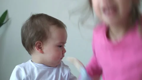 Authentic two joyful happy children, infant baby and 3-4 year old girl siting Stock Footage 150664123