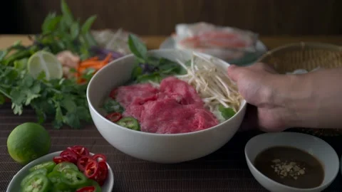 Authentic vietnamese pho rice noodle with raw beef Stock Footage 196261371