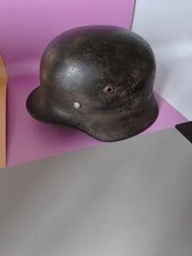 Authentic weathered world war era steel helmet on colorful background. 스톡 사진