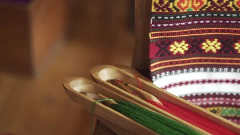 Authentic wooden spools with multicolored threads. Ukrainian folk Hutsul art Stock Footage 148230656