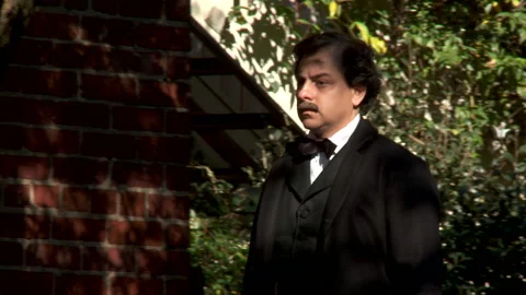 Author Edgar Allen Poe walking through a garden - Actor portrayal Stock Footage 221509652