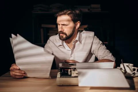 Author Reading Texts in a Study Lit by Morning Sun 스톡 사진