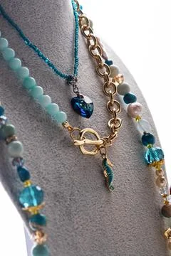 Author set with different blue colors  necklaces  presented on maneken agai.. Stock Photos