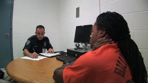 Authorities question a suspect at a jail. Video stock 74811995