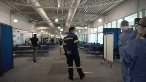 Authorities waiting for tourists to arrive to get COVID-19 tests at the Athe Stock Footage 142858874