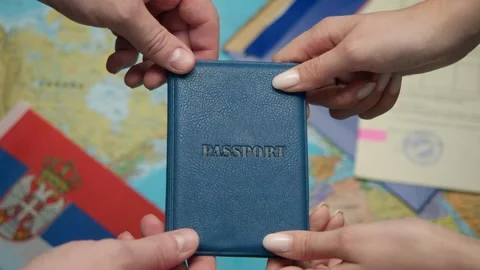 Authority representative offers Serbian passport to citizen with forms and Stock Footage 331262980