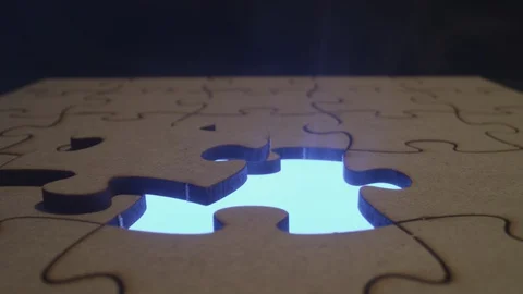 Autism Awareness - Solving a jigsaw puzzle dynamic cinematic imagery Stock Footage 129338446