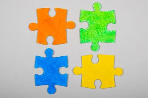 Autism symbol, different colored puzzles on a white background Stock Photos