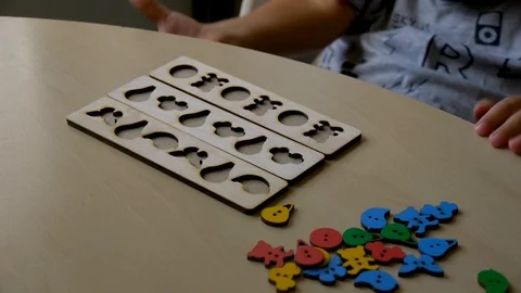 Autistic boy arranges objects in a form Stock-Footage 114762096