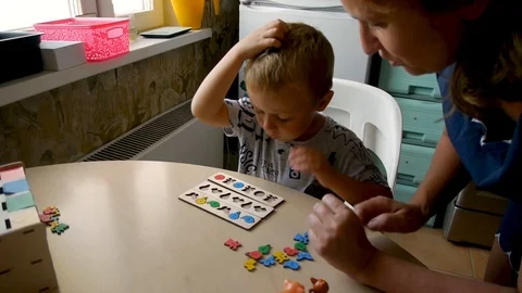 Autistic boy arranges objects in a form3 Stock-Footage 114762257