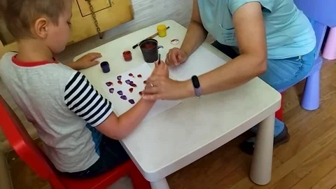 Autistic boy draws with paints Stock-Footage 221742765