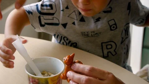 Autistic boy feeds kitty classes close up 스톡 동영상 114760503