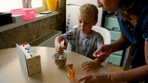 Autistic boy feeds kitty classes Stock Footage 114760507