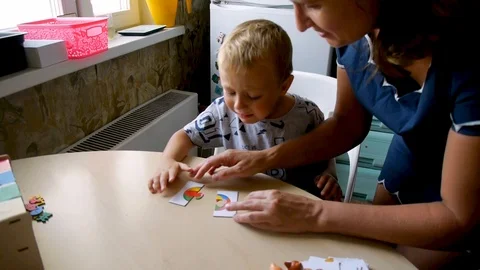 Autistic boy naughty while assembling a puzzle Stock-Footage 114745744