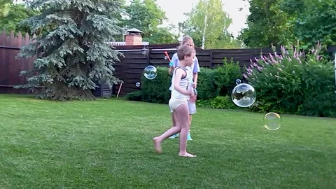 Autistic boy runs after soap bubbles Stock-Footage 221742779