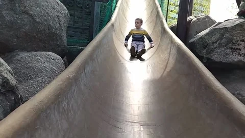Autistic boy slides down a long hill Stock-Footage 221742778