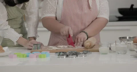 Autistic child practicing cake baking with mother in the kitchen at home Stock Footage 231770211