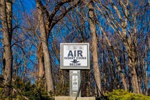 Auto air pump in front of trees Stock Photos