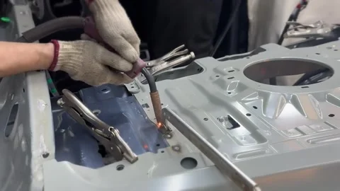 Auto Body Plug Welding on Car Sheet Metal Panel With Flying Sparks 動画素材 348691238