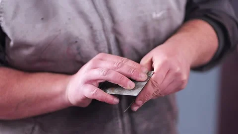 Auto Body Technician Cleaning Putty Knives from Polyester Filler Close Up Stock Footage 331675175