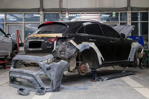 Auto bumper part from tuning package Renegade on the floor before painting an Stock Photos