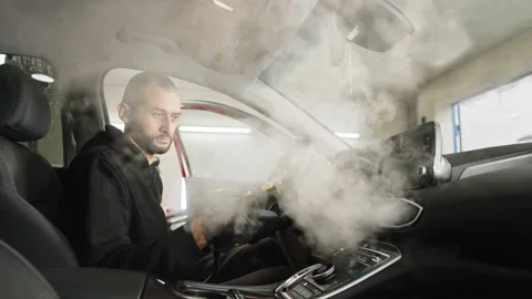 Auto cleaning service and detailing concept. Handsome bearded man in uniform Stock Footage 233993090