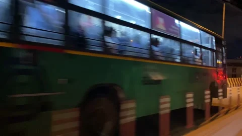 Auto driver overtaking public transport bus on flyover at night Stock Footage 162980657