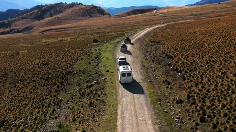 Auto expedition in mountains. The drone camera follows cars. Travelling by car. Stock Footage 144189723