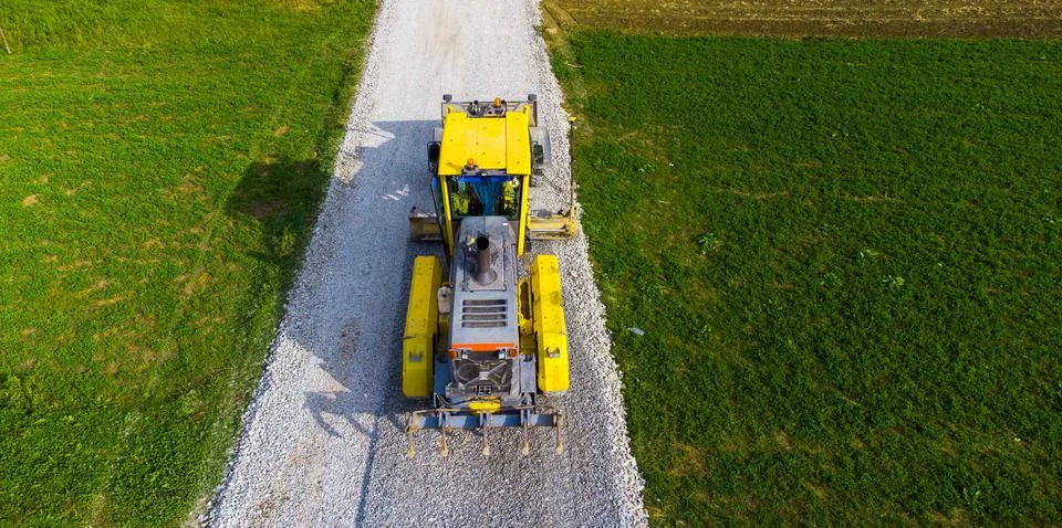 Auto grader preparing for road construction 库存照片