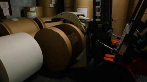 Auto loader unloads a large roll of paper Stock Footage 129305948