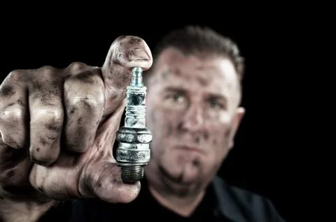 Auto mechanic and sparkplug Stock Photos