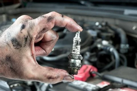 Auto mechanic and sparkplug Stock Photos