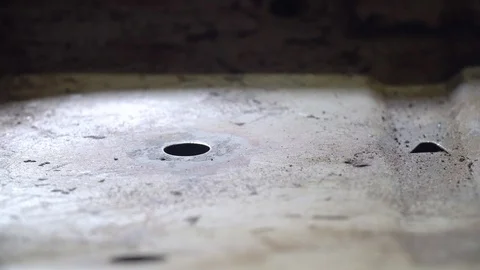 Auto mechanic brushes bottom of car inside cabin from rust and old paint Stock Footage 127458007