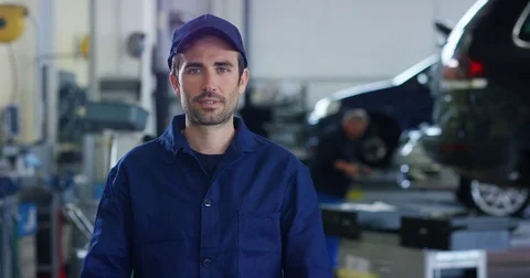 An auto mechanic in a car service, checks the machine diagnostics. Stock Footage