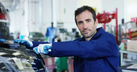 An auto mechanic in a car service, checks the machine diagnostics. Stock Footage